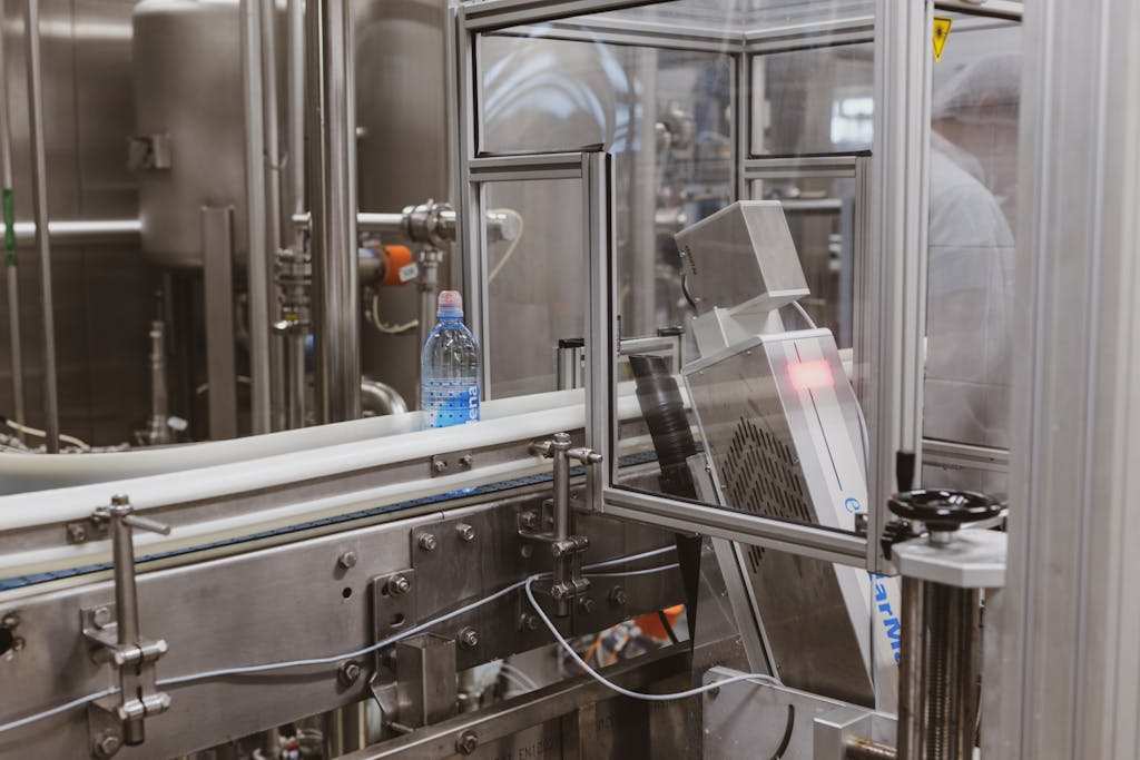 Close-up of a plastic bottle in a modern factory bottling production line.