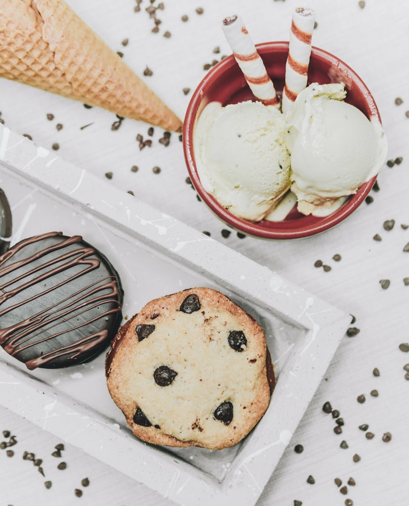 Overhead view of cookies and ice cream with a cone, perfect for sweet cravings.